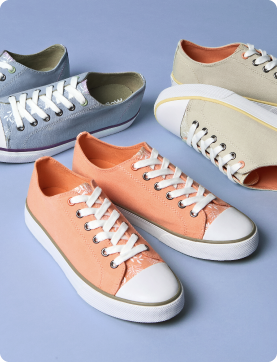 Four pairs of sneakers in different colors on a light blue background
