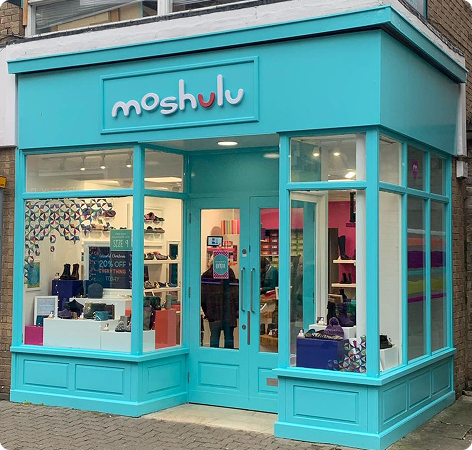 Blue store front with 'moshulu' branding